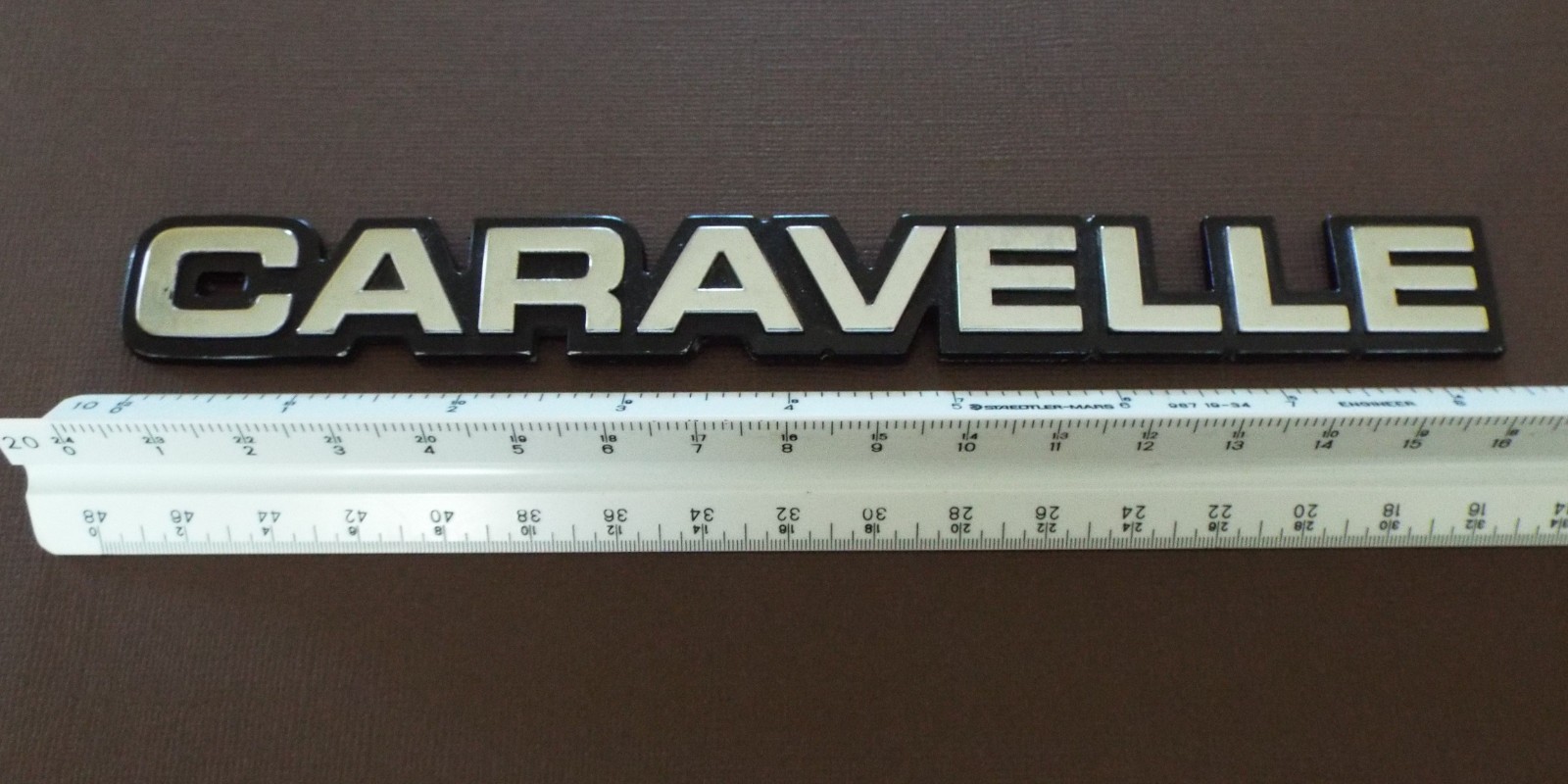 Nice 85-86-87-88 Plymouth Caravelle Trunk Lid Emblem